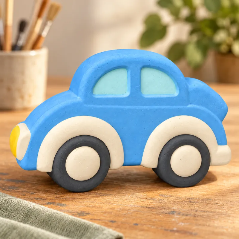 Painted Little City Car plaster figure on a craft table; color inspiration only